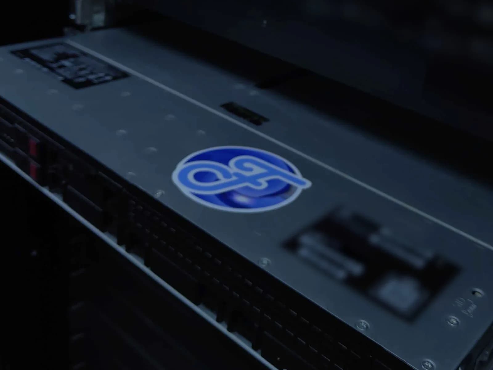 Close-up of a FreshPerf server chassis, its blue logo sticker on the lid